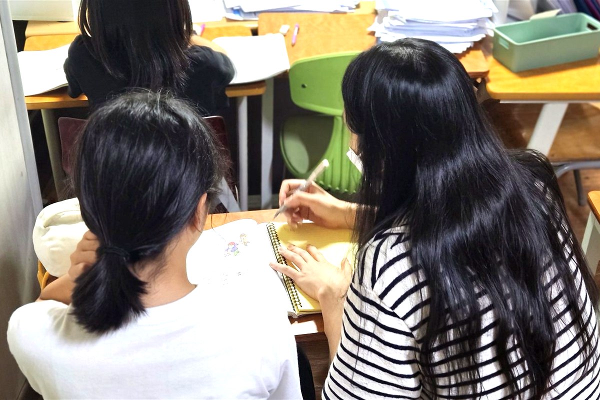 백마 초등영어학원 로라쌤이 학생 옆에서 개인별 맞춤으로 영어를 지도하는 모습